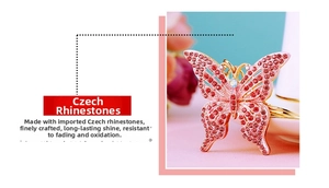 Close-up of pink Czech crystal butterfly keychain with gold plating and rhinestones