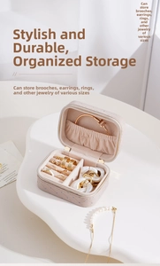 Detailed view of nude pink leather jewelry box with rhinestone trim and plush compartments