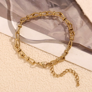 Macro shot of 14K gold-plated horseshoe link chain with adjustable lobster clasp