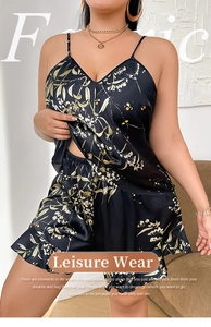 Detail of black cherry print satin pajamas showing silky fabric texture and v-neck strap