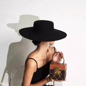 Classic wide brim wool felt hat for women paired with a vintage monogram box handbag