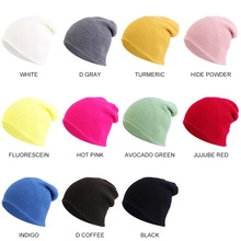 Flat lay display of 11 vibrant knit beanie colors including yellow, pink, and blue
