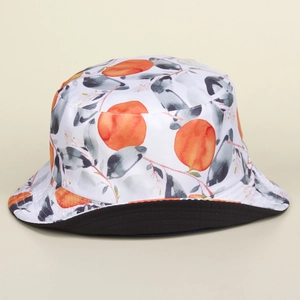 Detailed view of reversible cotton bucket hat with vibrant watercolor orange prints