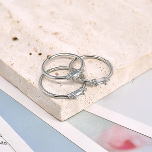 Macro shot of silver stackable rings set with rectangular cubic zirconia on stone base