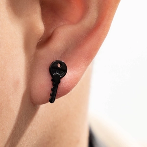 Cool black stainless steel key shaped stud earring worn by a male for trendy fashion