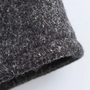 Macro shot of the thick grey wool blend fabric texture on the coat sleeve cuff
