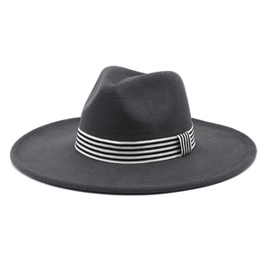 Detail of dark grey wide brim wool fedora hat with black and white striped ribbon band