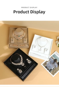 Luxurious velvet jewelry trays displaying gold and silver necklace, ring, and earring sets