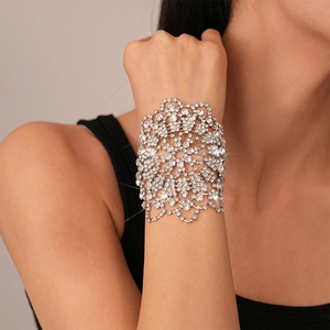 Close-up of luxury wide lace bracelet featuring intricate hollow flower patterns and full crystals