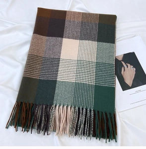 Close-up of thick plaid tassel scarf in earthy tones of brown and beige cashmere