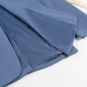 Detailed close-up of blue wool coat inner lining and pocket stitching craftsmanship
