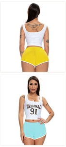 Close-up of sporty two-piece set featuring white crop top and colorful athletic shorts