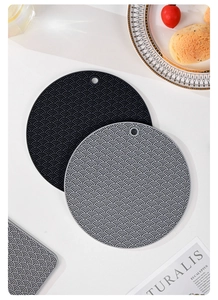 Close-up of heat resistant silicone pot mats with wave texture in grey and black