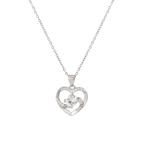 Detailed macro view of heart-shaped silver necklace featuring a sparkling round center gem