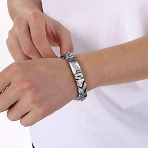 Men's 11mm stainless steel wheat chain bracelet with matte finish on male model wrist
