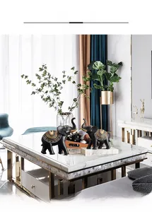 Modern resin elephant statues set with gold geometric patterns in a bright living room