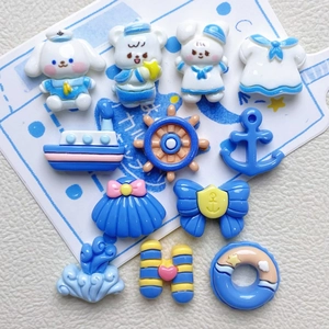 Flat lay of nautical resin charms including boat, anchor, and cartoon animals for DIY crafts
