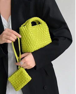 Detail of bright green woven mini bucket bag with matching small coin purse for women