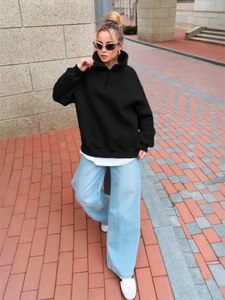 Detail of black oversized hoodie with ribbed cuffs and adjustable drawstring collar