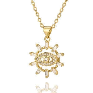 Golden Evil Eye pendant necklace with baguette zircons on a white reflective background