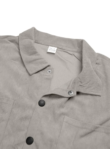 Detail of grey corduroy shirt collar with 100% polyester fabric texture and button closure