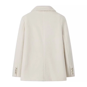 Detail view of the back of an off-white plush jacket with button-decorated cuffs