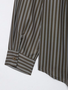 Detail of striped poplin shirt showing single-button cuff and curved side hem finish