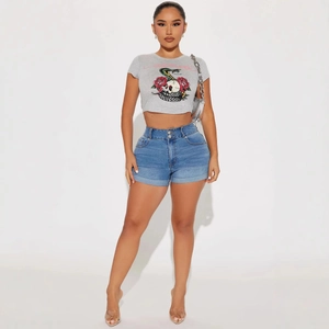Slim fit high-waisted blue denim shorts with a cropped grey graphic T-shirt set