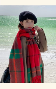 Outdoor shot of thick red and green plaid fringe scarf with black beret at the lake