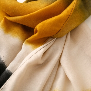 Detailed macro view of yellow and white gradient scarf with woven texture and neat stitching