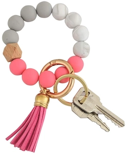 Silicone and wood bead keychain bracelet with pink tassel and gold metal ring detail