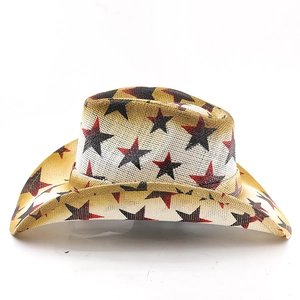 Close-up of woven straw cowboy hat with red and black star print and wide curled brim