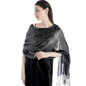 Close-up of elegant dark grey shawl with shimmering silver silk and fringe details
