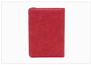 Close-up of red RFID passport holder showing faux leather texture and fine stitching
