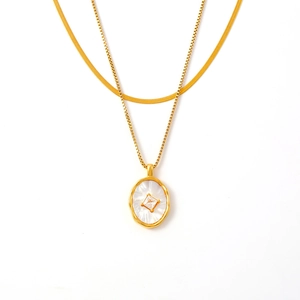 Double-layered gold necklace with snake chain and oval mother-of-pearl zircon pendant