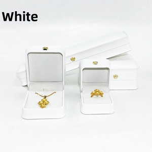Detailed set of white PU leather jewelry boxes with golden crown accent and jewelry