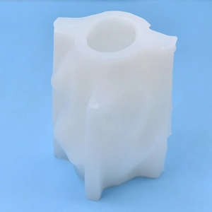 White silicone mold for abstract female torso candle DIY on a solid blue background