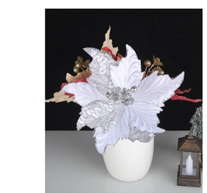 Detail of a white artificial poinsettia with silver glitter and embossed petal textures