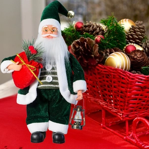 Close-up of standing Santa figurine with green velvet suit and golden lantern decor