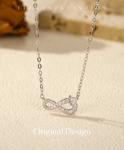 Macro shot of silver S925 infinity pendant featuring sparkling pavé cubic zirconia