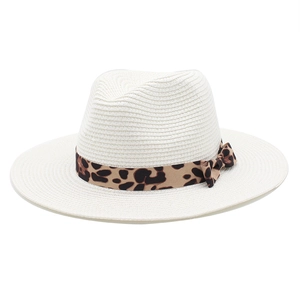 Detail of white straw fedora hat featuring leopard print ribbon and bow decoration
