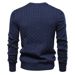 Rear view of navy blue cable knit sweater showing detailed texture and ribbed hem