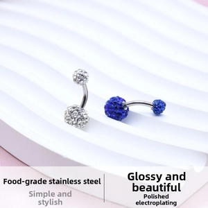 Detailed view of polished food-grade stainless steel belly rings with pave crystal balls