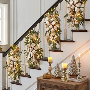 Set of 4 Christmas stair swags with green branches, gold bows and warm LED lights