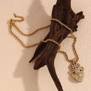 Detailed view of an 18K gold plated crown lion pendant with diamonds on a rope chain