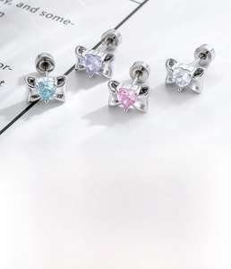 Detail view of heart zircon bow earrings set in four colors with screw back design