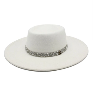 Detail of white wool fedora hat featuring a sparkling rhinestone band and M-letter metal badge