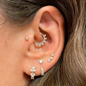 Detailed view of gold S925 silver earrings set with zircon studs and heart hoop styles