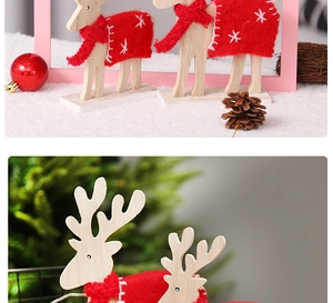 Detail view of two wooden Christmas reindeer ornaments with red scarves and festive cloaks