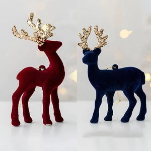 Detail of red and blue flocked reindeer ornaments with sparkling gold glitter antlers
